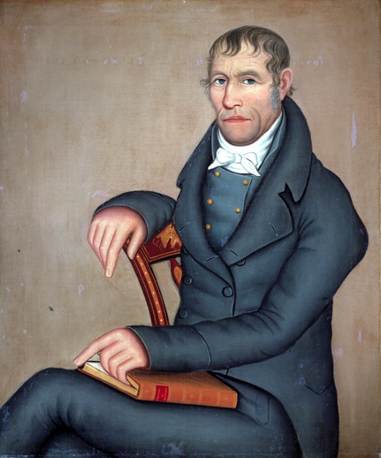 Painting by Ammi Phillips Joseph Slade (1816). Seated man wearing a dark gray suit with a book on his lap.