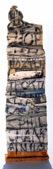 Sculpture by Claes Oldenburg titled Letter Tenement (1960). Tower of rags with words painted on the surface.