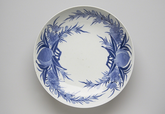 Edo period Nabeshima ware titled Dish with Peach Pattern (1700s). Round plate with blue peach design on white background.