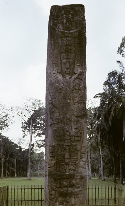 Maya Stele E (Monument 5) (771 CE) from Quiriguá in Guatemala. Tall carved stone with image of K'ak Tiliw Chan Yopaat wearing a large headdress.