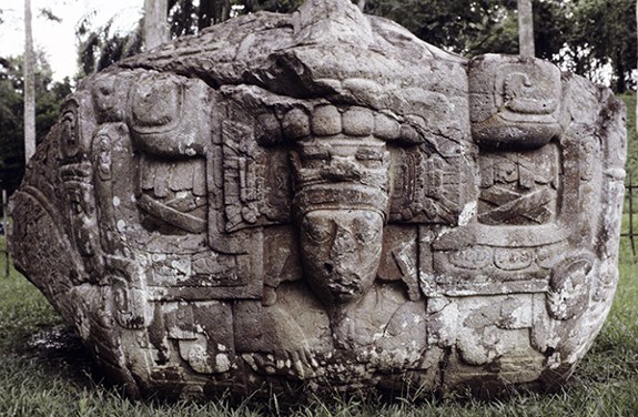 Maya Zoomorph B (Monument 2) (780 CE) from Quiriguá in Guatemala. Rounded stone carved with a creature made of a snake, a crocodile, and a jaguar with K'ak Tiliw Chan Yopaat emerging from the mouth.