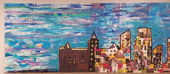 Collaborative collage mural by sixteen art educators and Alice Mizrachi titled Minneapolis Skyline (2024). Cityscape of the Minneapolis skyline with colorful buildings and blue sky.