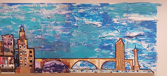 Collaborative collage mural by sixteen art educators and Alice Mizrachi titled Minneapolis Skyline (2024). Cityscape of the Minneapolis skyline with colorful buildings and blue sky.