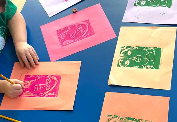 A second-grade student uses Warholʼs Factory method to create a series of self-portraits.