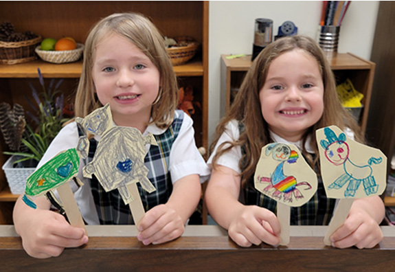 Kindergartners share the paper puppets they made in a choice-based TAB art room.