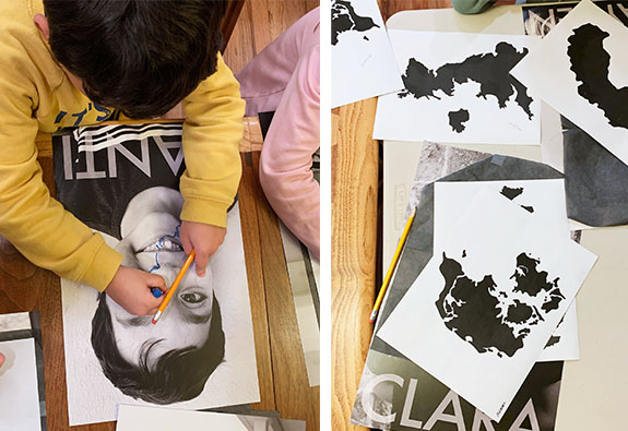 Left: Santi, grade two, uses an oil pastel to trace his drawing of Sweden. Right: Clara, grade two, will use these printouts to trace her countries of origin over her photograph.